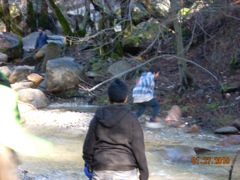 Students crossing a running creek